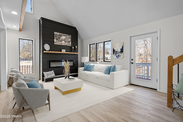 129 Remuda Dr, Lords Valley, PA 18428 - living room featuring a healthy amount of sunlight, a large fireplace, recessed lighting, and wood finished floors