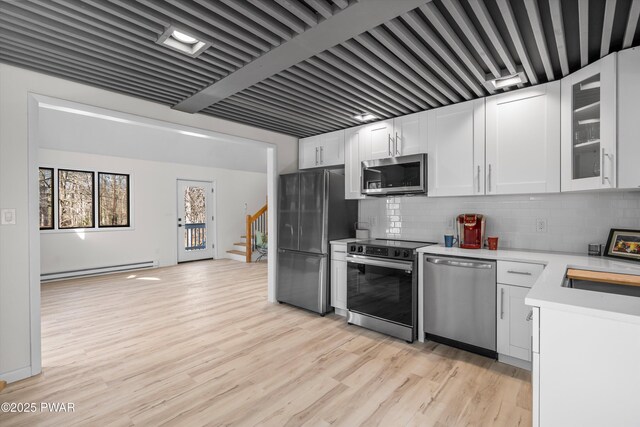 129 Remuda Dr, Lords Valley, PA 18428 - kitchen featuring light countertops, white cabinets, appliances with stainless steel finishes, and decorative backsplash