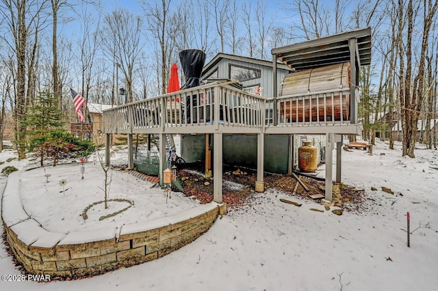 snow covered house featuring a deck