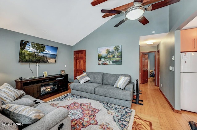 living room featuring high vaulted ceiling, light hardwood / wood-style floors, and ceiling fan