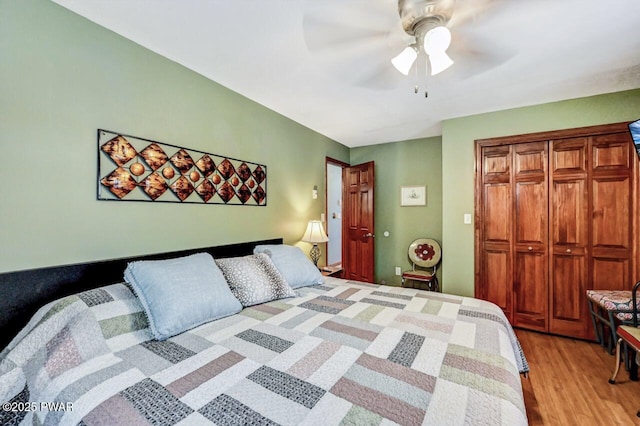 bedroom with ceiling fan, light hardwood / wood-style floors, and a closet