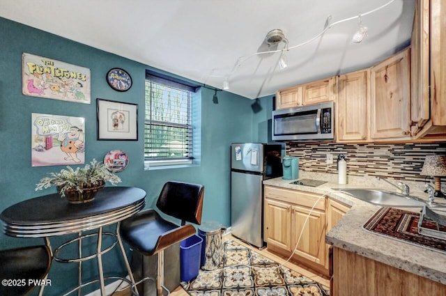 kitchen featuring tasteful backsplash, appliances with stainless steel finishes, sink, and light brown cabinetry