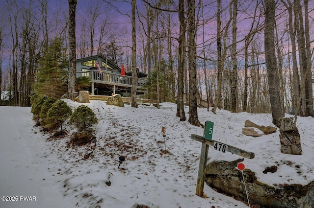 snowy yard with a deck