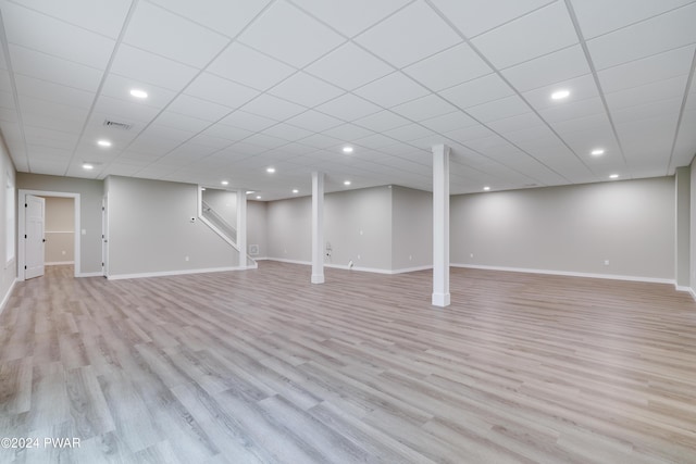 basement with light hardwood / wood-style flooring