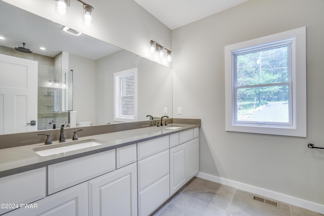 bathroom featuring vanity, toilet, and a shower with door