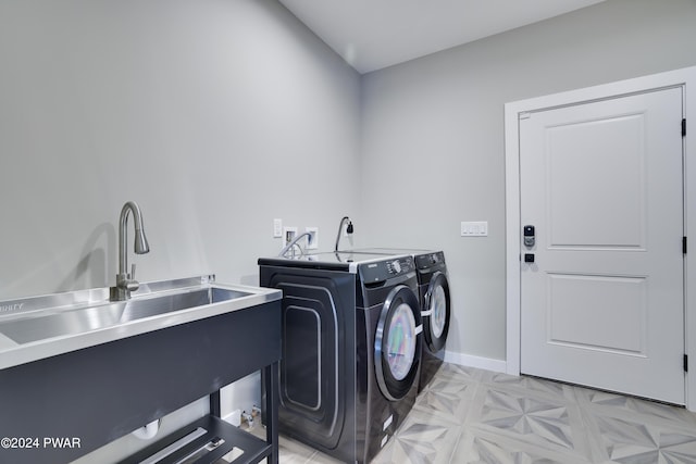 laundry area featuring washer and clothes dryer and sink