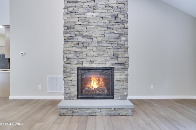 details featuring a stone fireplace and hardwood / wood-style flooring