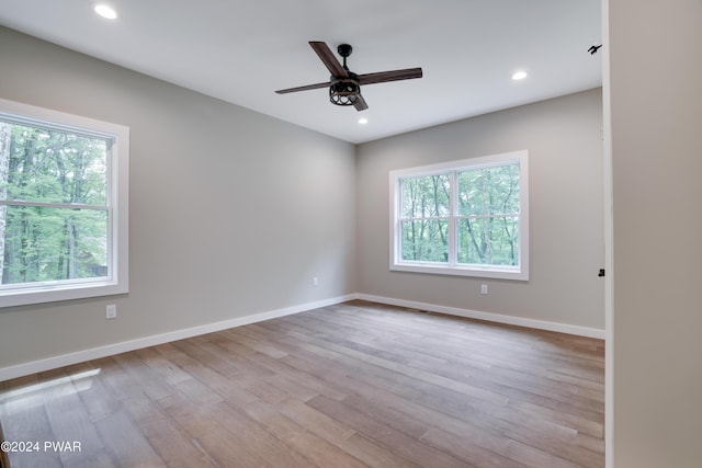 empty room featuring ceiling fan and light hardwood / wood-style floors