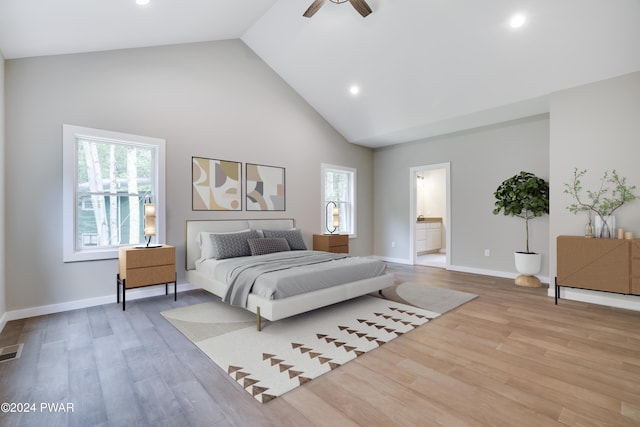 bedroom featuring multiple windows, ceiling fan, light hardwood / wood-style flooring, and ensuite bathroom