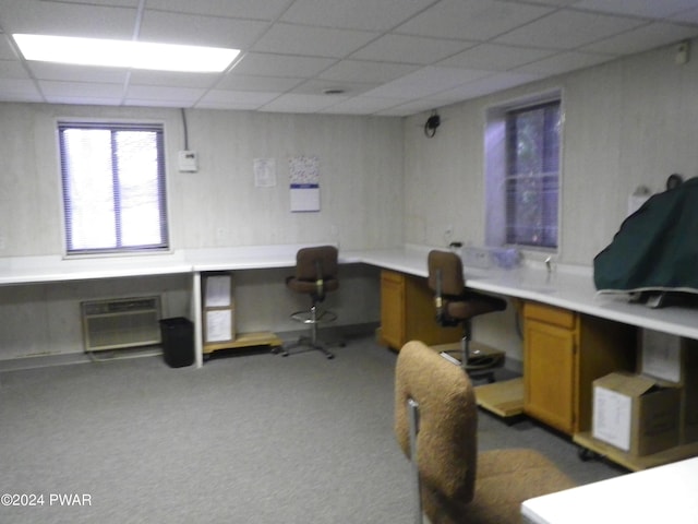 home office featuring a wall mounted AC, carpet floors, and built in desk