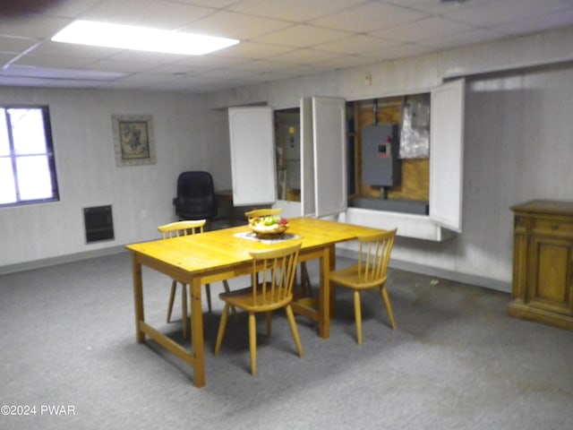 dining room with a paneled ceiling and electric panel