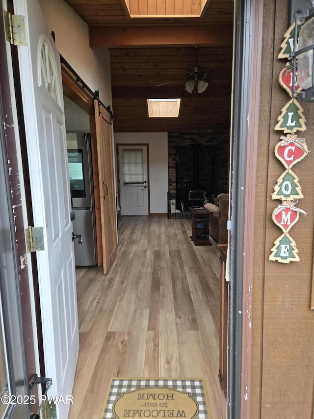 100 Saddlebrook Ln, Lords Valley, PA 18428 - corridor featuring light wood finished floors, a barn door, and beam ceiling