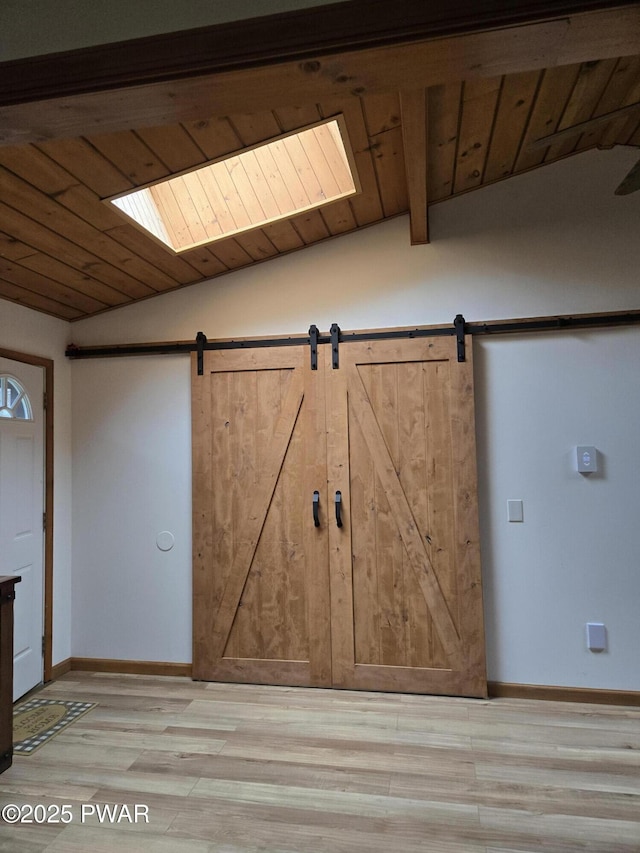 100 Saddlebrook Ln, Lords Valley, PA 18428 - interior space with light wood-style flooring, wood ceiling, a barn door, and baseboards