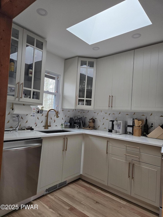 100 Saddlebrook Ln, Lords Valley, PA 18428 - kitchen with stainless steel dishwasher, a sink, a skylight, decorative backsplash, and recessed lighting