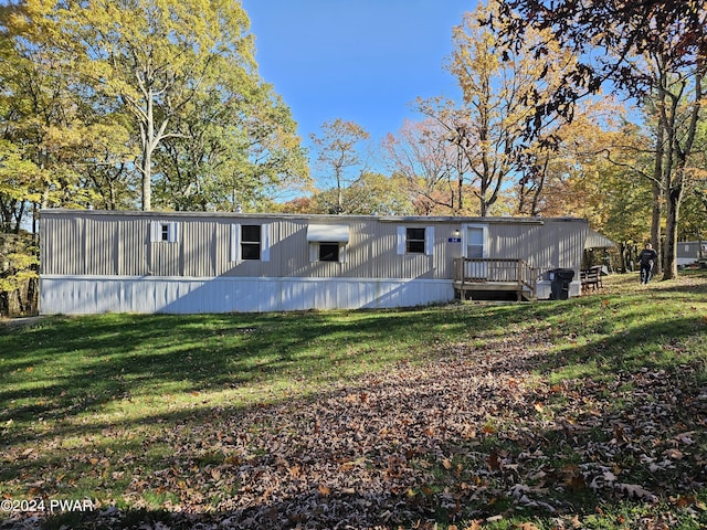 back of property featuring a lawn