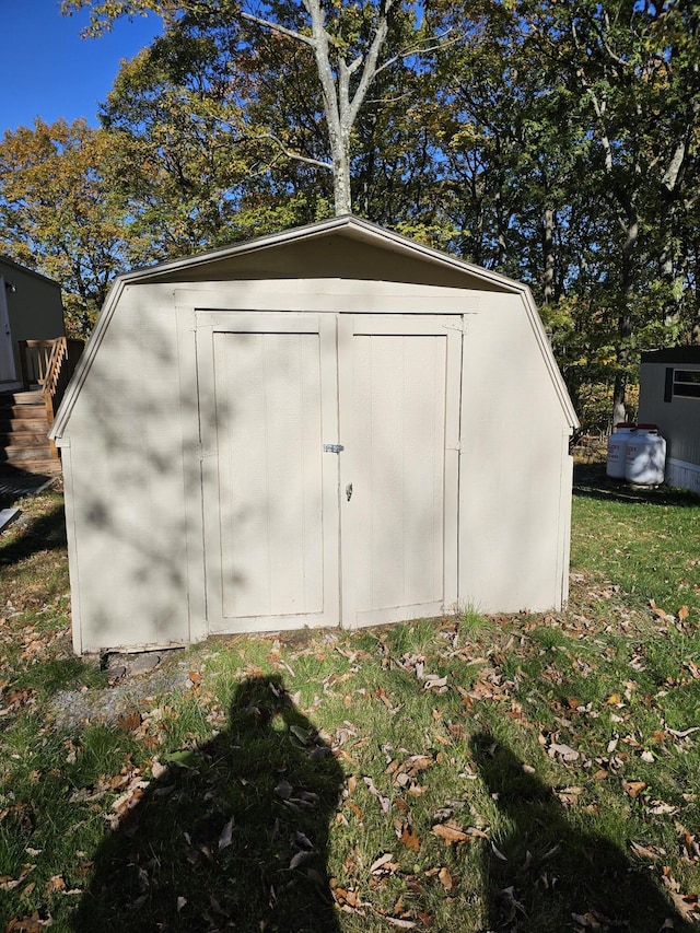 view of outbuilding featuring a yard