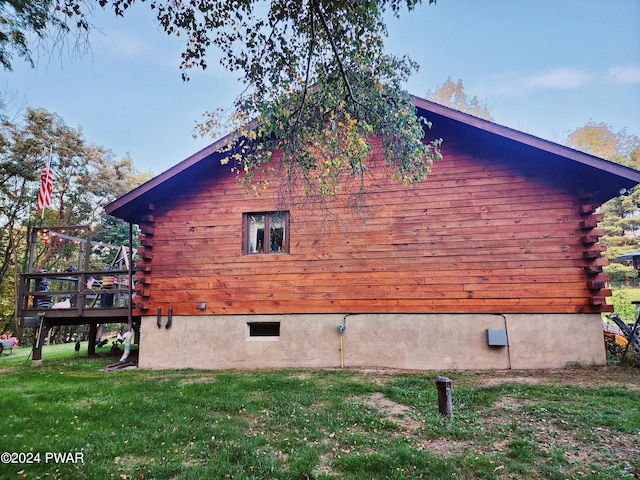 view of home's exterior featuring a lawn and a wooden deck