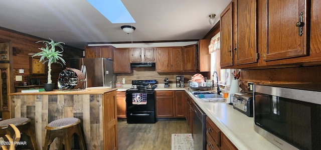 145 Father John Dr, Lake Ariel, PA 18436 - kitchen featuring appliances with stainless steel finishes, a sink, range hood, light countertops, and a skylight