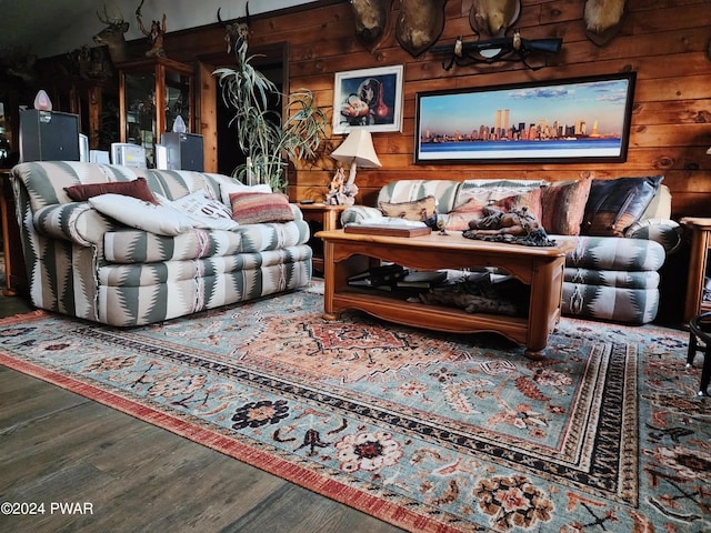 living room with hardwood / wood-style floors and wooden walls