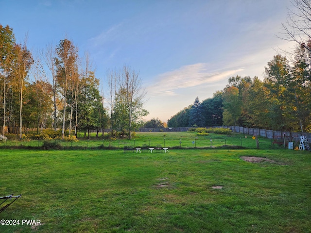 yard at dusk with a rural view