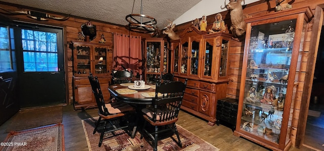 145 Father John Dr, Lake Ariel, PA 18436 - dining room featuring a textured ceiling, lofted ceiling, light wood-type flooring, and wooden walls