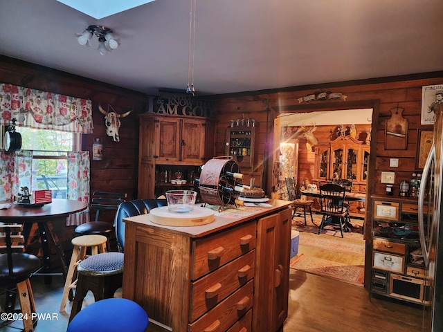 kitchen with hardwood / wood-style flooring, stainless steel fridge, and a center island