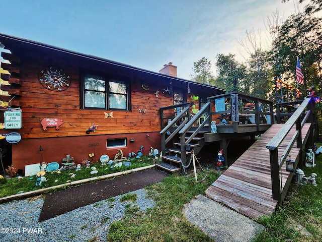 back of property featuring a wooden deck