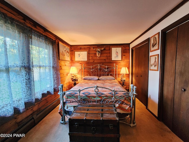 carpeted bedroom featuring wood walls, crown molding, and a baseboard heating unit