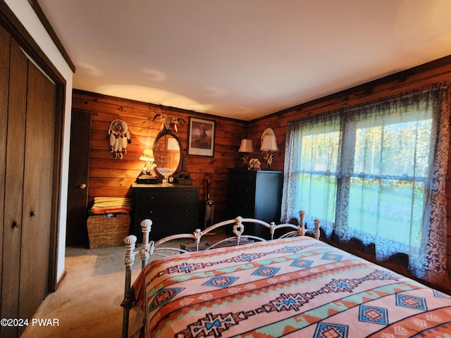 bedroom featuring light colored carpet, wooden walls, and a closet