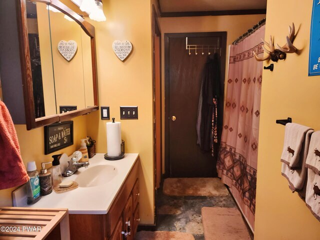 bathroom featuring vanity and a shower with shower curtain