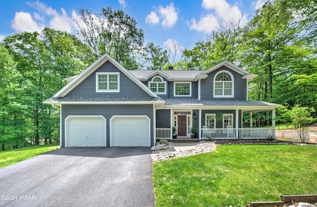 view of front facade with a porch, a garage, and a front lawn