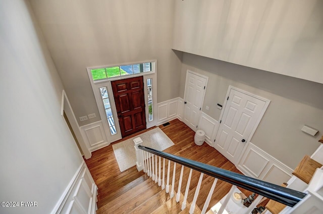 foyer entrance featuring light hardwood / wood-style floors and a high ceiling