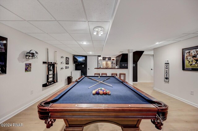 recreation room with a paneled ceiling, billiards, and light wood-type flooring