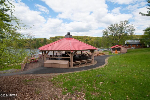 surrounding community with a water view and an outbuilding