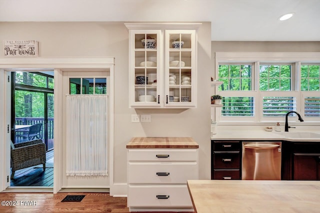 doorway to outside with dark hardwood / wood-style flooring and sink