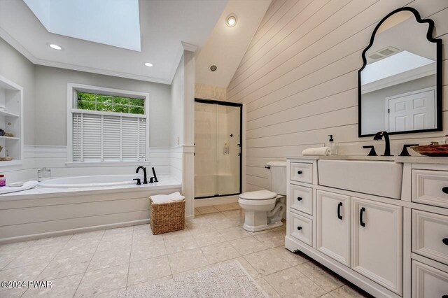 full bathroom with a skylight, built in features, separate shower and tub, tile patterned floors, and toilet