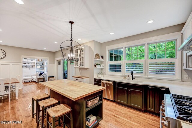 kitchen with sink, a kitchen bar, white cabinetry, and stainless steel appliances