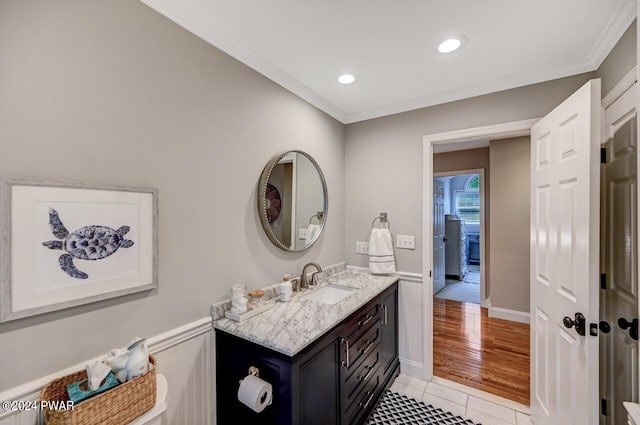 bathroom with tile patterned flooring, vanity, and ornamental molding