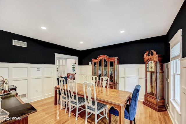 dining area with light hardwood / wood-style flooring and a wealth of natural light