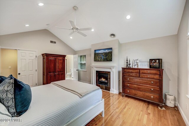 bedroom featuring ceiling fan, lofted ceiling, and light hardwood / wood-style flooring