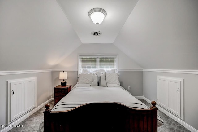 bedroom with carpet floors and vaulted ceiling