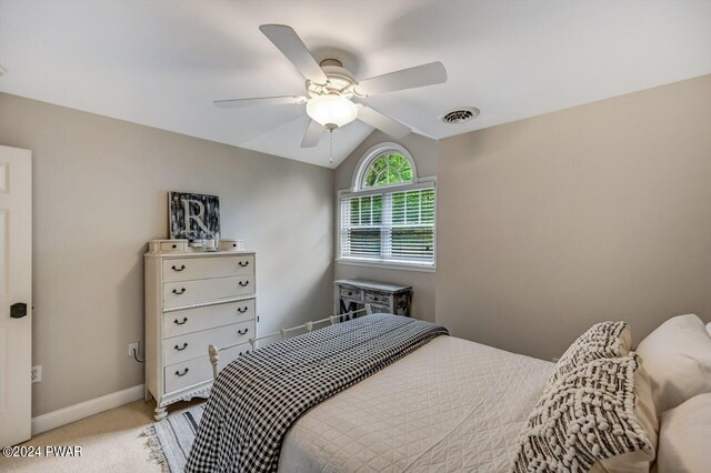 carpeted bedroom featuring ceiling fan and lofted ceiling