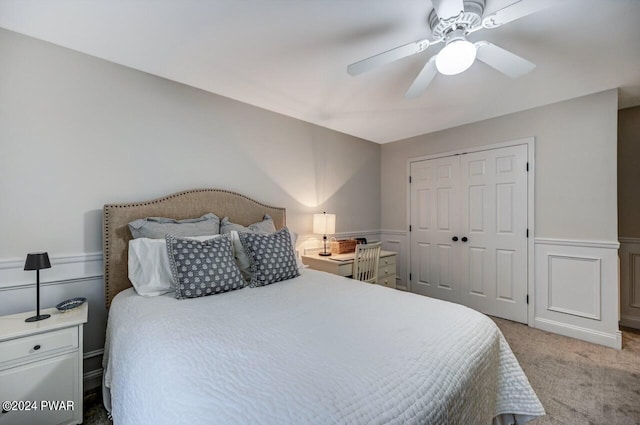 bedroom with ceiling fan, a closet, and light carpet