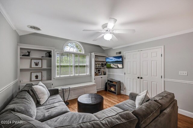 living room with ceiling fan, crown molding, and light hardwood / wood-style floors