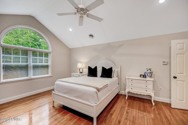 bedroom with ceiling fan, light hardwood / wood-style floors, and lofted ceiling