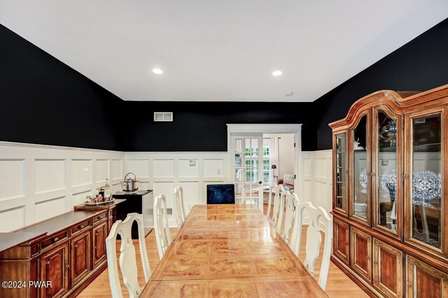 dining space with light hardwood / wood-style floors and french doors