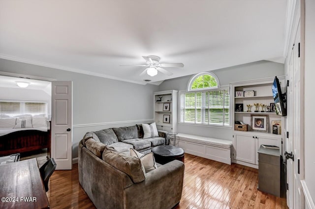 living room with ceiling fan, crown molding, and light hardwood / wood-style flooring