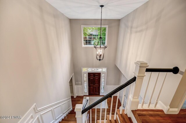 stairway featuring a chandelier and wood-type flooring