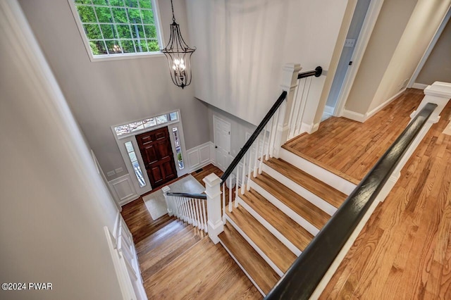 entrance foyer featuring a chandelier, hardwood / wood-style floors, and a high ceiling