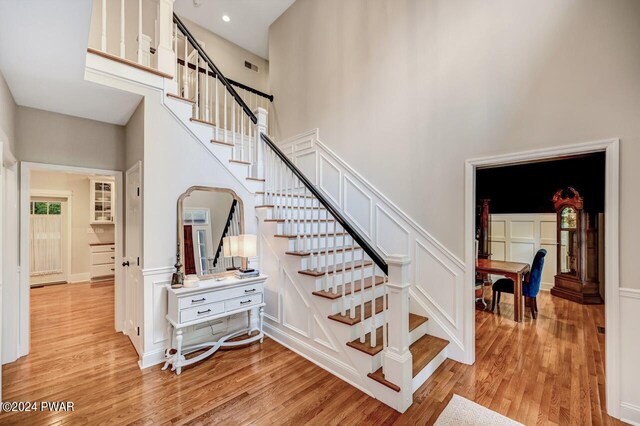 staircase with hardwood / wood-style floors